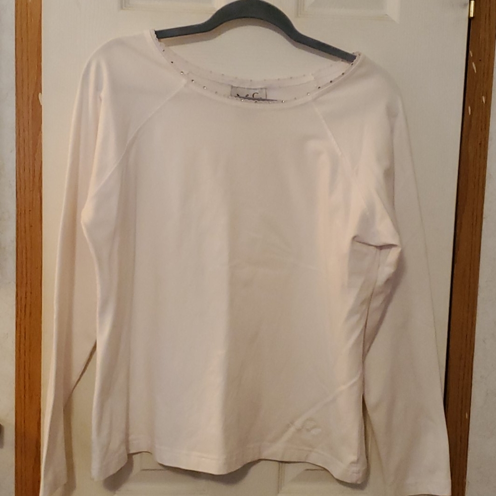 A cream colored blouse with sequin collar